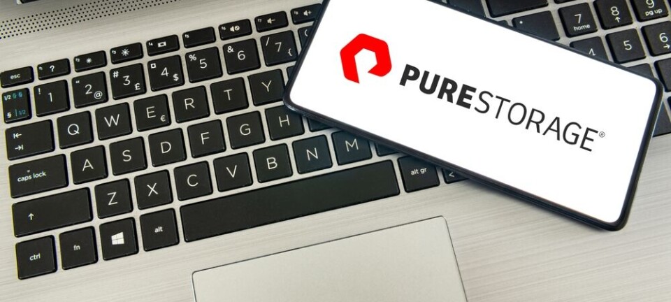 Pure Storage logo on smartphone, laying on a laptop